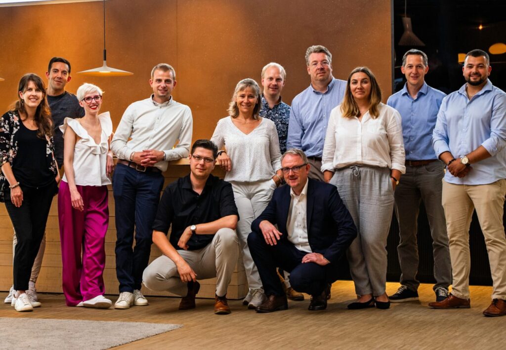 Group of professionals posing in a modern office, ready for web designers collaboration.